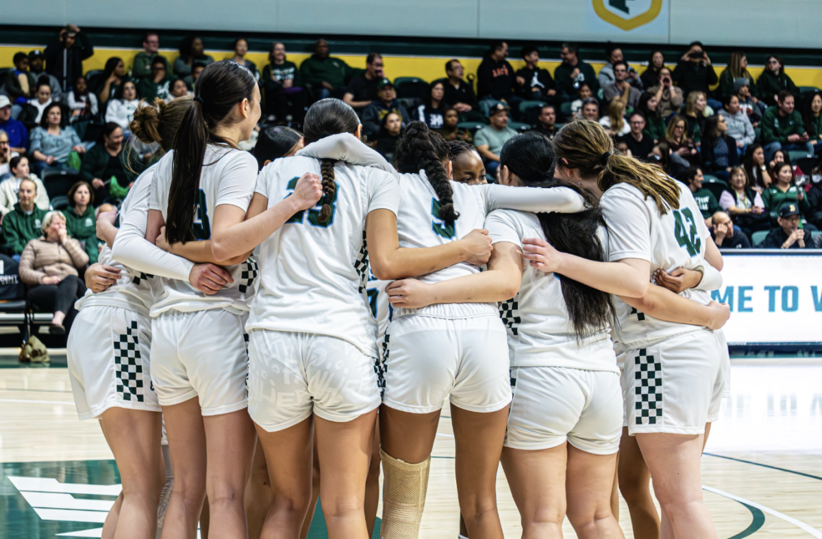 The SHC Girls’ Basketball Team embracing each other in a group hug during last year’s Girls' Bruce Mahoney Basketball Game.